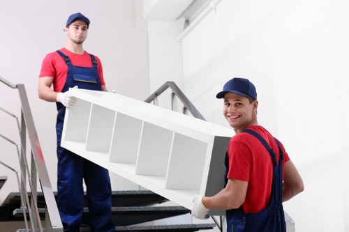 Removal team sorting recyclable packing materials at a local London property