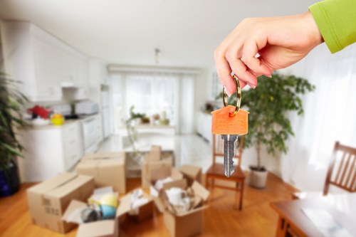 Local moving team handling boxes in a Stockwell property