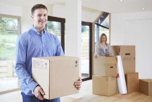 Professional movers carrying boxes and furniture for a local home move