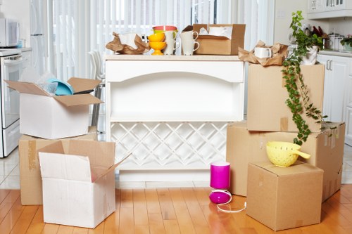 Professional movers transporting office furniture in South London